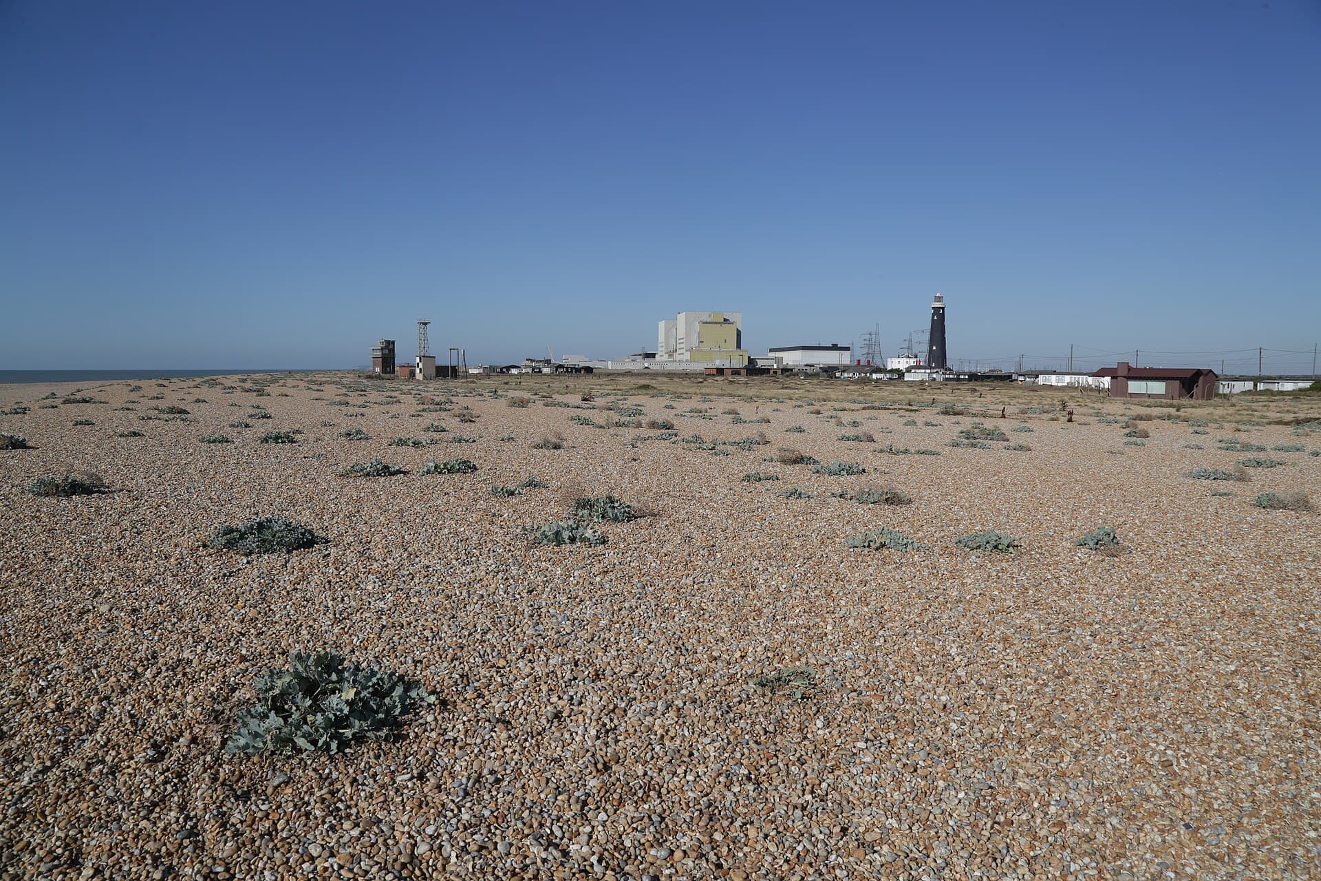 Open shingle at Dungeness with the old lighthouse and power station on the horizon