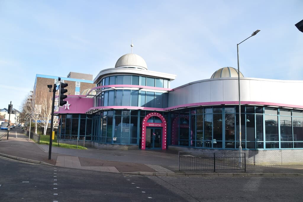Domed white and pink building of Hollywood Bowl in Ashford