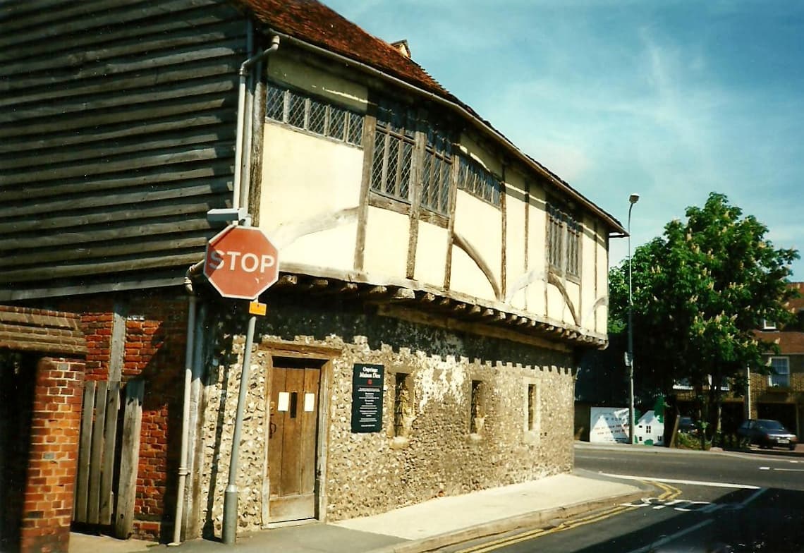 The jettied timber-framed upper floor of Maison Dieu above a flint ground floor on a street corner in Ospringe